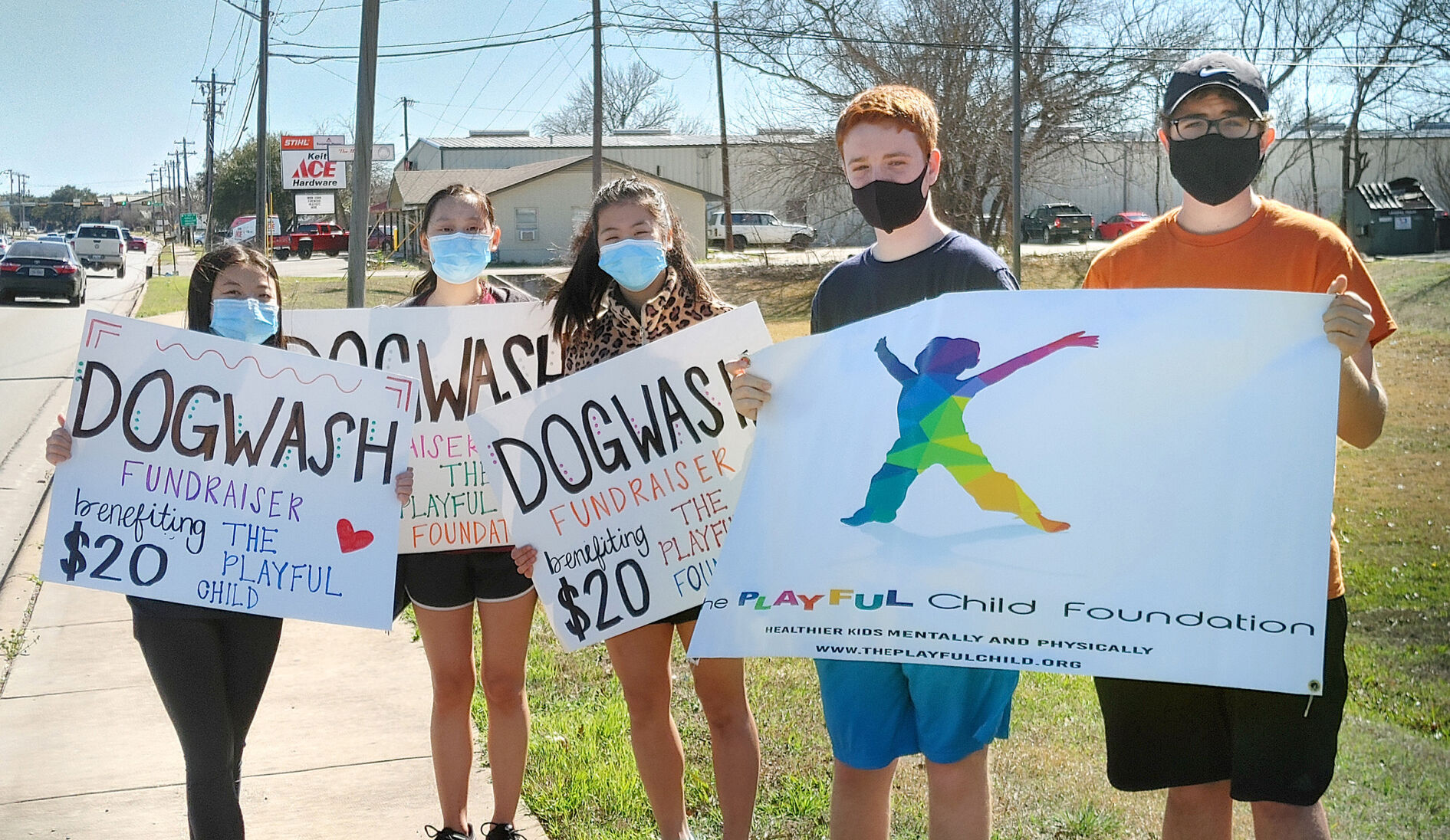 Students with signs at Wag Heaven Fundraising Dog Wash for The Playful Child Foundation 02-27-21 300dpi.jpg